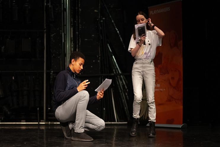 boy and girl reading from scripts