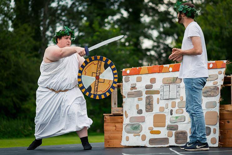 two young men performing outdoors at a festival