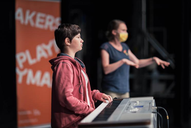Young person playing the keyboard
